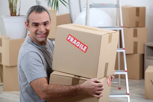 Professional movers loading furniture for a Harrow relocation