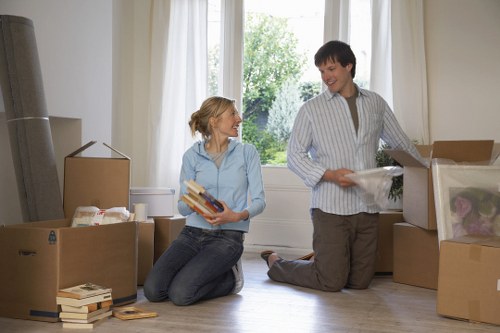 Mover carrying furniture carefully through a flat in Harrow