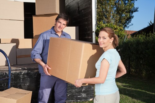 Professional movers carrying furniture during a house move in Harrow